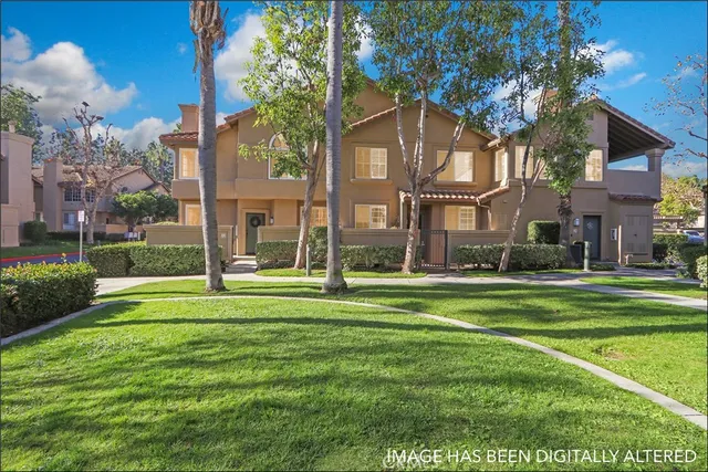 a view of a big house in a big yard with large trees