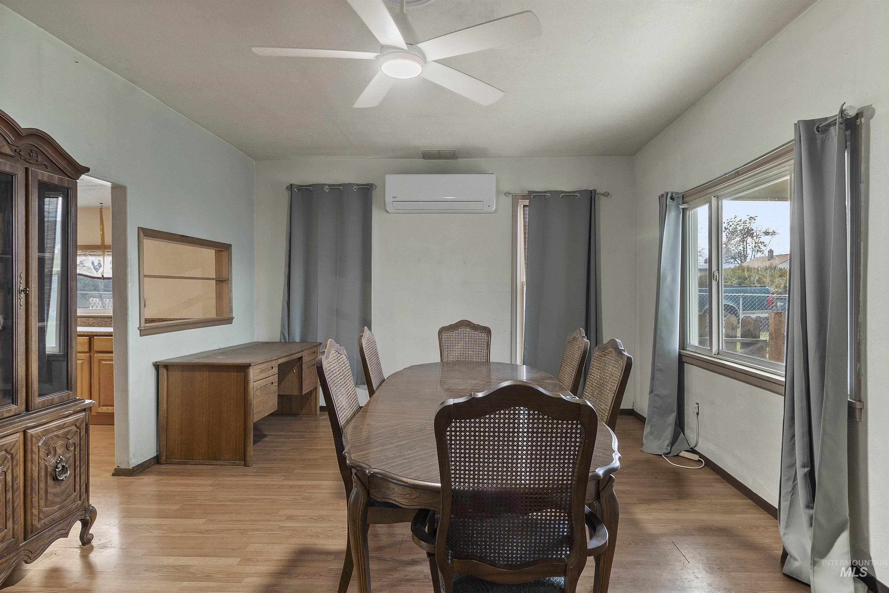 721 9th Street Clarkston, WA 99403 - Photo 11 of 39 Dining space with light wood-style flooring, a mini split for heating / cooling, and a ceiling fan