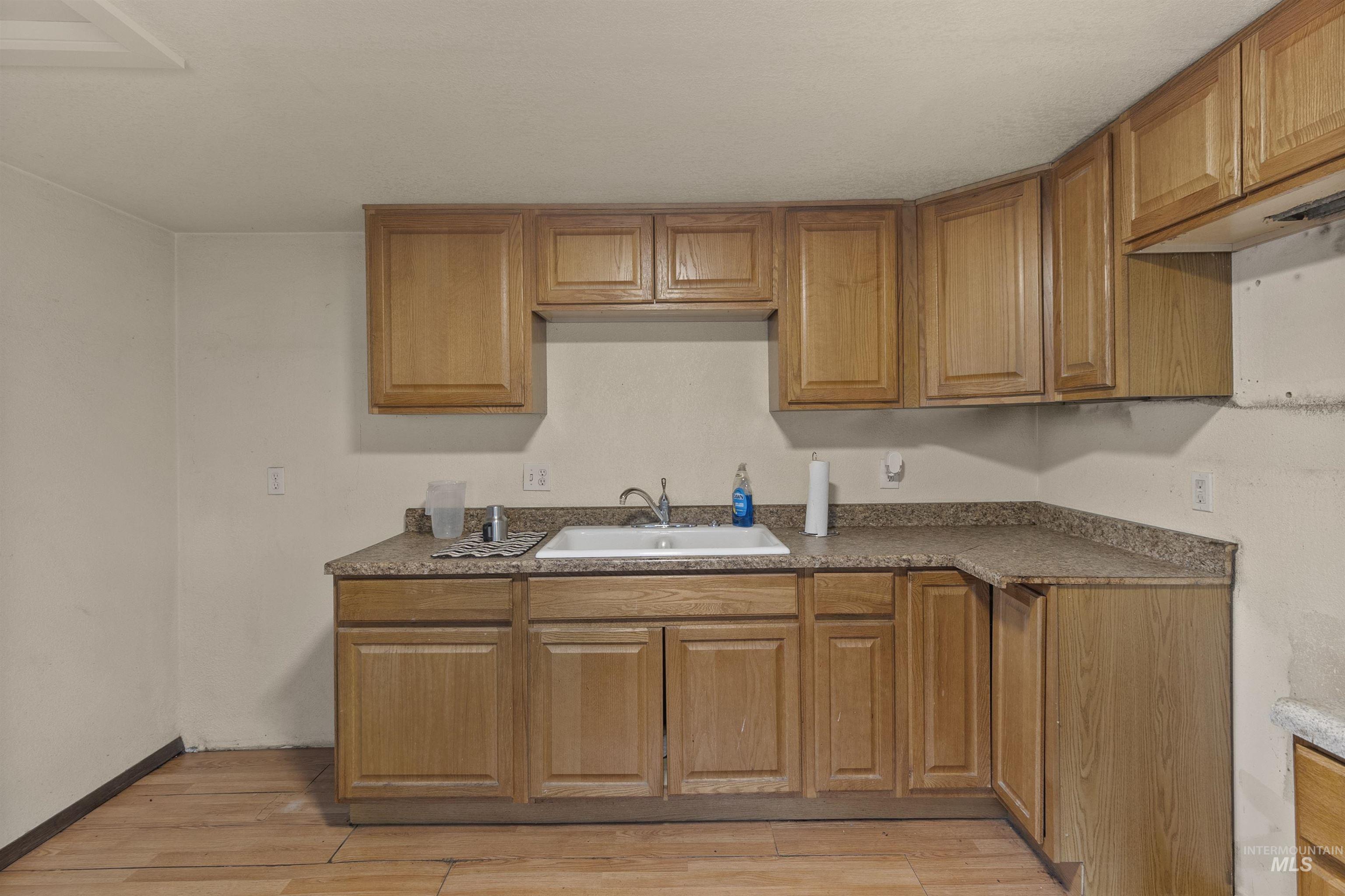 721 9th Street Clarkston, WA 99403 - Photo 17 of 39 Kitchen featuring light wood-style floors and wood finish cabinetry