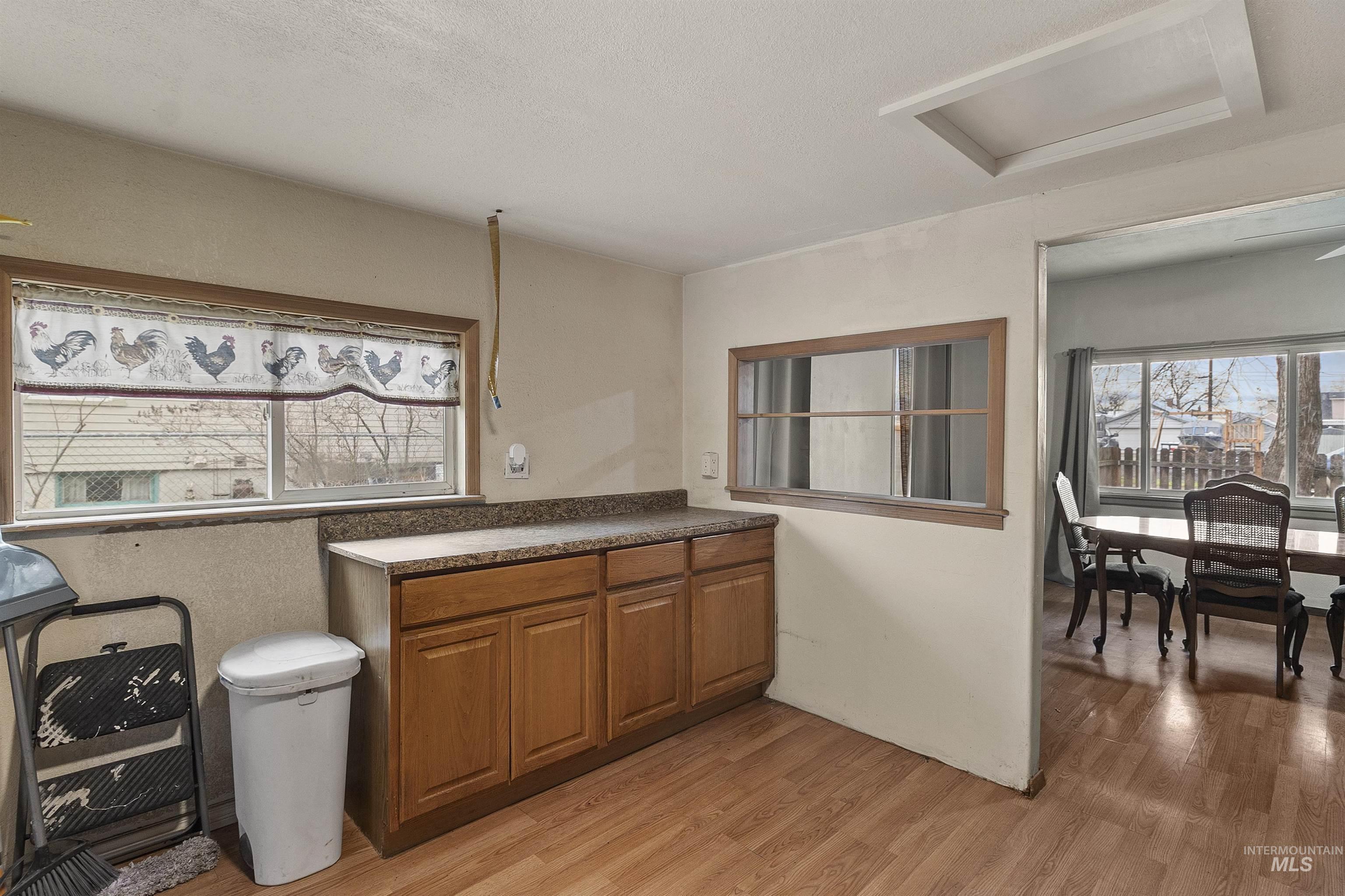 721 9th Street Clarkston, WA 99403 - Photo 19 of 39 Kitchen with wood finish cabinets, light wood finished floors, and dark countertops