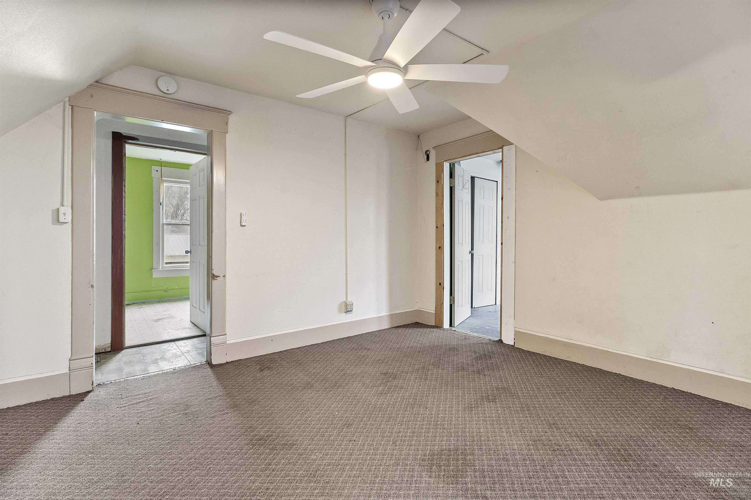 721 9th Street Clarkston, WA 99403 - Photo 35 of 39 Bonus room with vaulted ceiling, carpet, and a ceiling fan