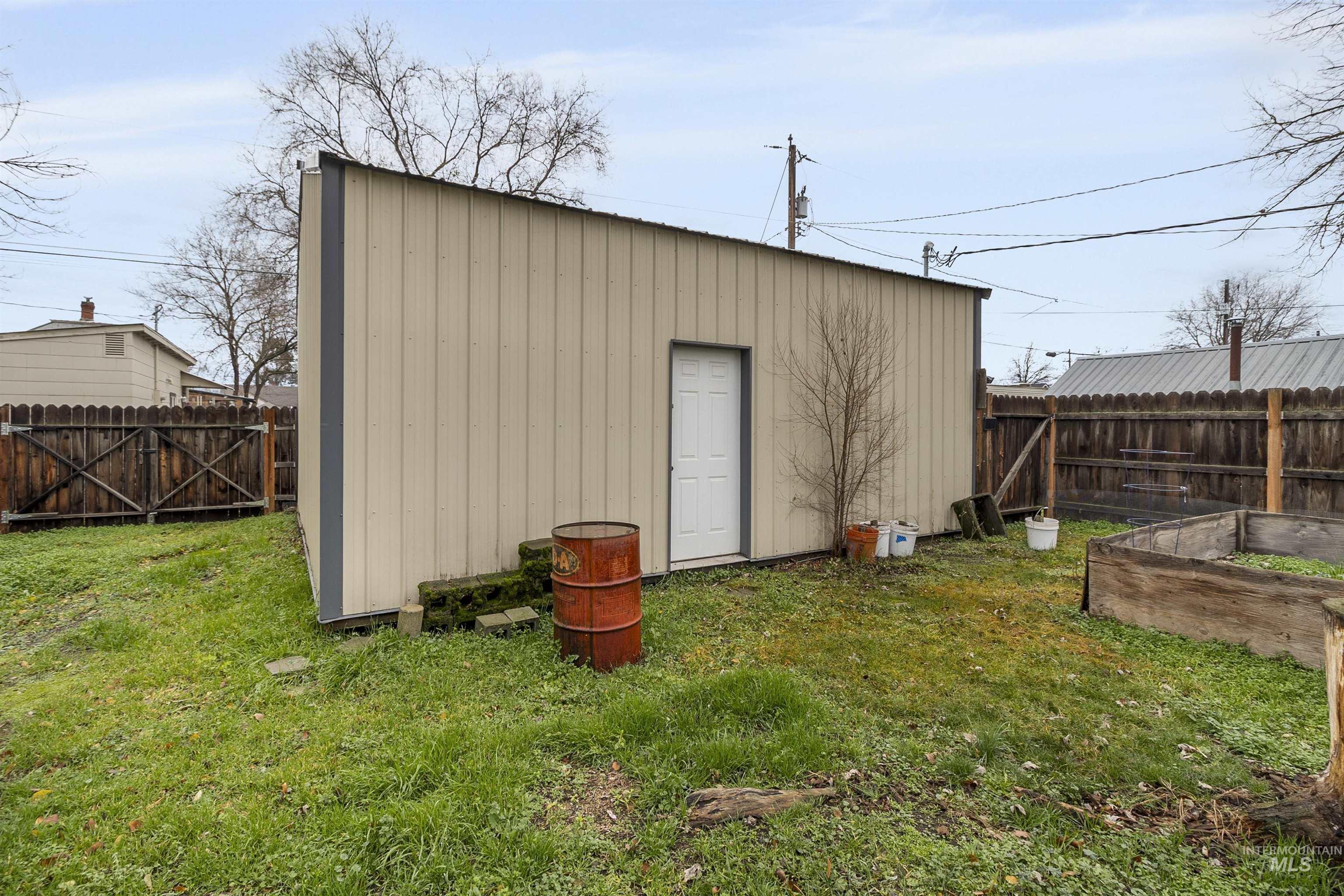 721 9th Street Clarkston, WA 99403 - Photo 8 of 39 View of outbuilding with a garden, a fenced backyard, and a gate