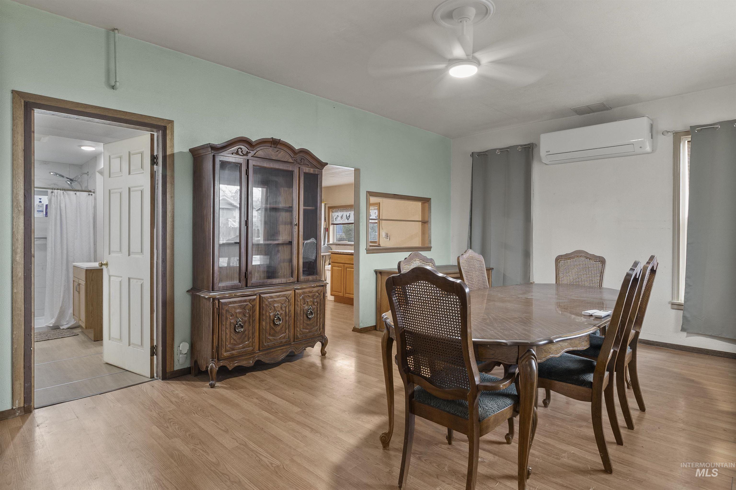 721 9th Street Clarkston, WA 99403 - Photo 9 of 39 Dining room featuring ceiling fan, light wood-style floors, and a wall mounted mini split