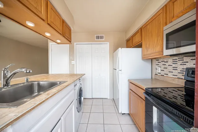 a kitchen with a sink stove and refrigerator
