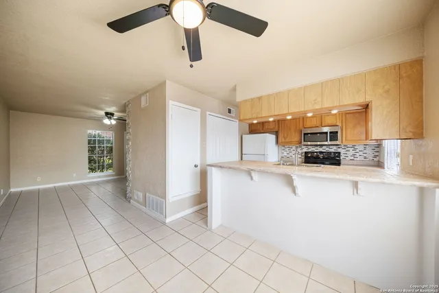 a view of a kitchen with electric appliances