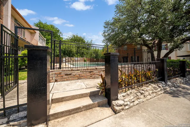 a view of a pathway with a garden