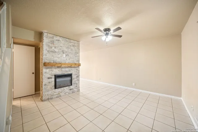 a view of an empty room with a fireplace
