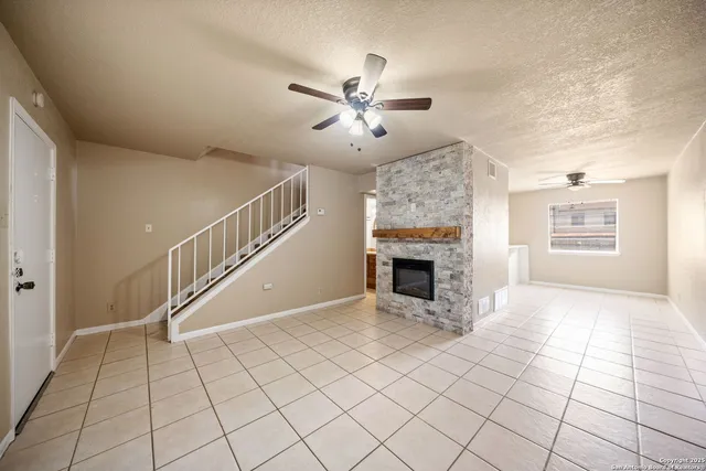 a view of an empty room with a fireplace