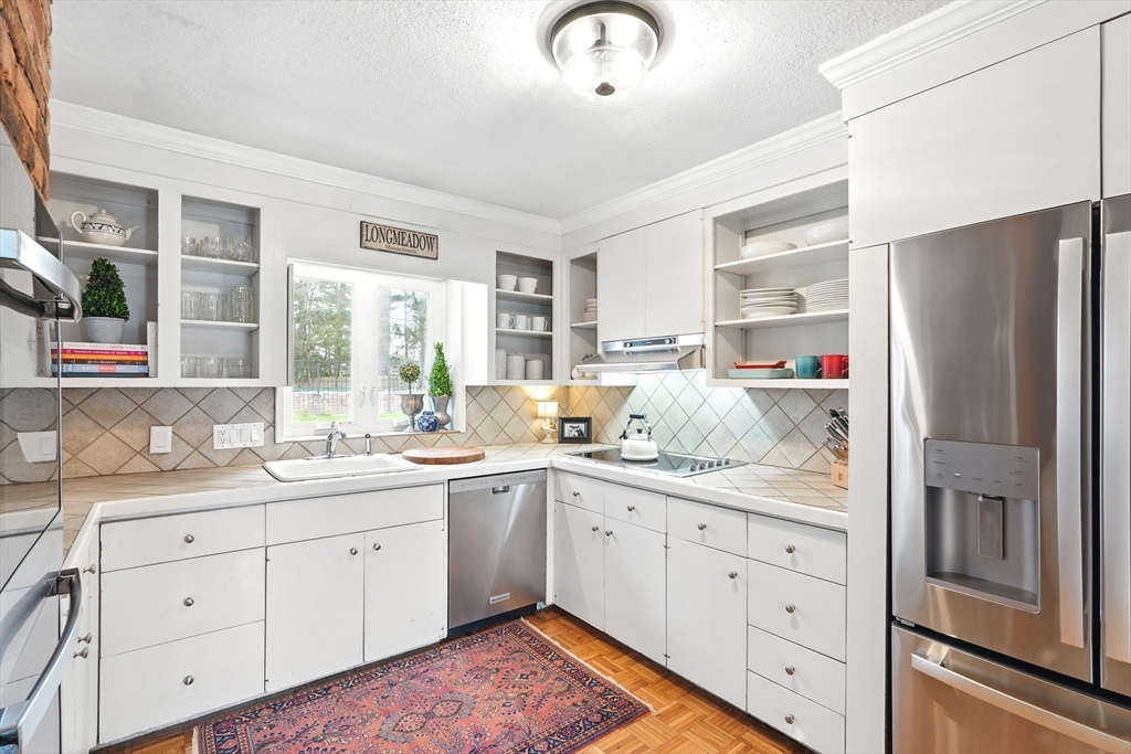 249 Concord Road Longmeadow, MA 01106 - Photo 11 of 41 a kitchen with a sink dishwasher and white cabinets with wooden floor