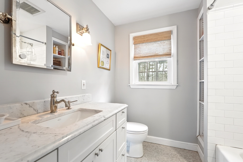 249 Concord Road Longmeadow, MA 01106 - Photo 30 of 41 a bathroom with a granite countertop toilet sink and mirror