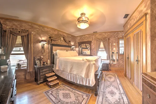a bedroom with a bed couch and a window