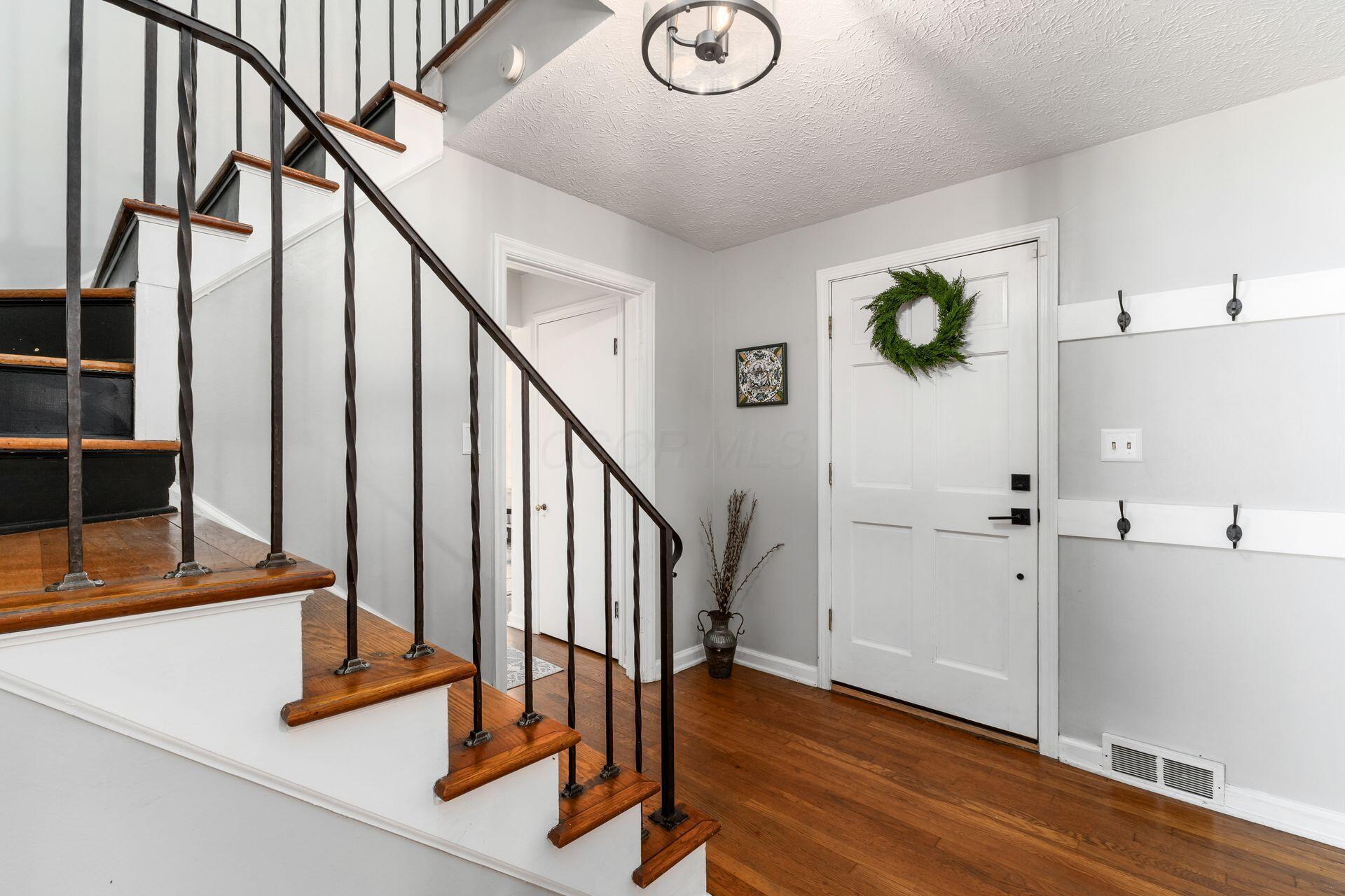 128 South Kellner Road Columbus, OH 43209 - Photo 6 of 53 Entry Foyer - 12'0" x 9'0" - Wood Floors, Coat Closet, Wrought Iron Railing