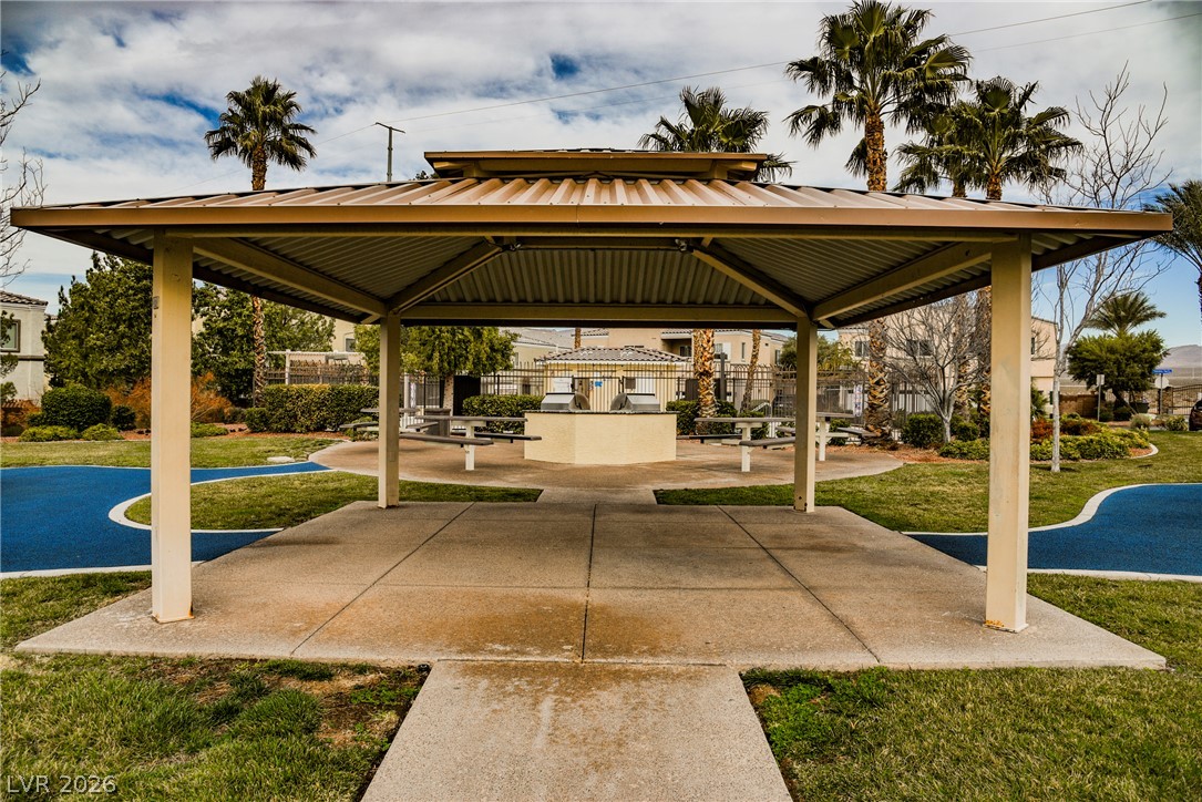 6320 Snap Ridge Street, Unit 201 North Las Vegas, NV 89081 - Photo 43 of 56 Gathering space with a barbecue area, picnic tables, and ample green space under a covered pavilion.