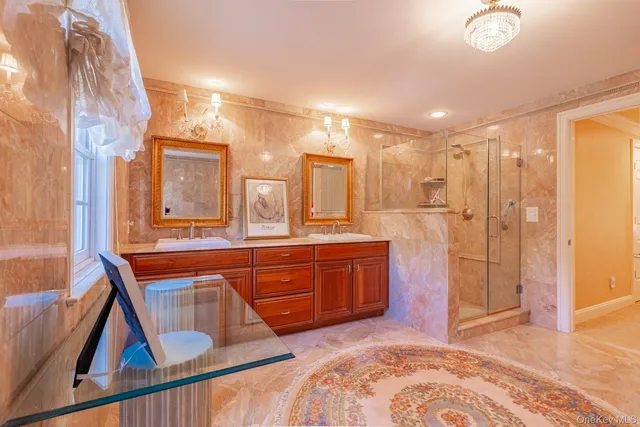 a spacious bathroom with a sink a mirror a bathtub and shower