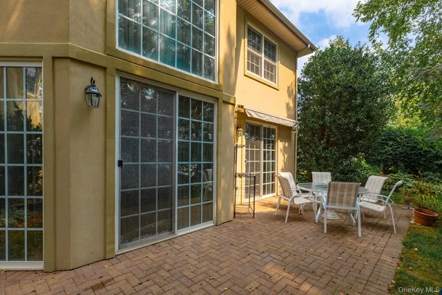 a front view of a house with a yard and potted plants