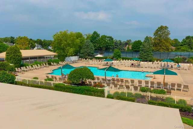 a living room with patio furniture and a large window
