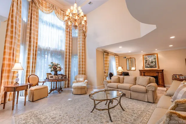 a living room with furniture and a chandelier