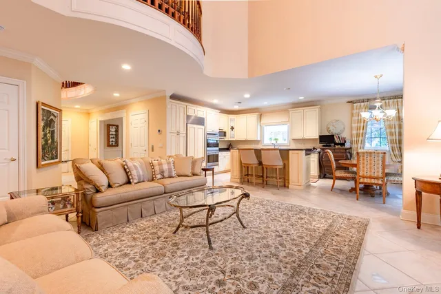 a living room with furniture and a dining table with kitchen view