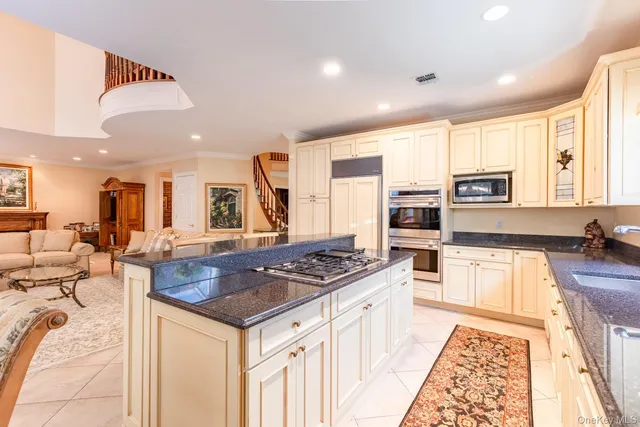 a kitchen with stainless steel appliances granite countertop a stove and a sink
