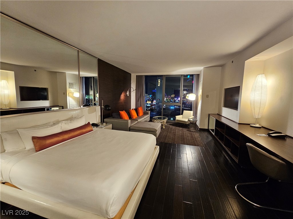 4381 West Flamingo Road, Unit 1806 Las Vegas, NV 89103 - Photo 5 of 12 Bedroom featuring dark wood-style flooring and floor to ceiling windows