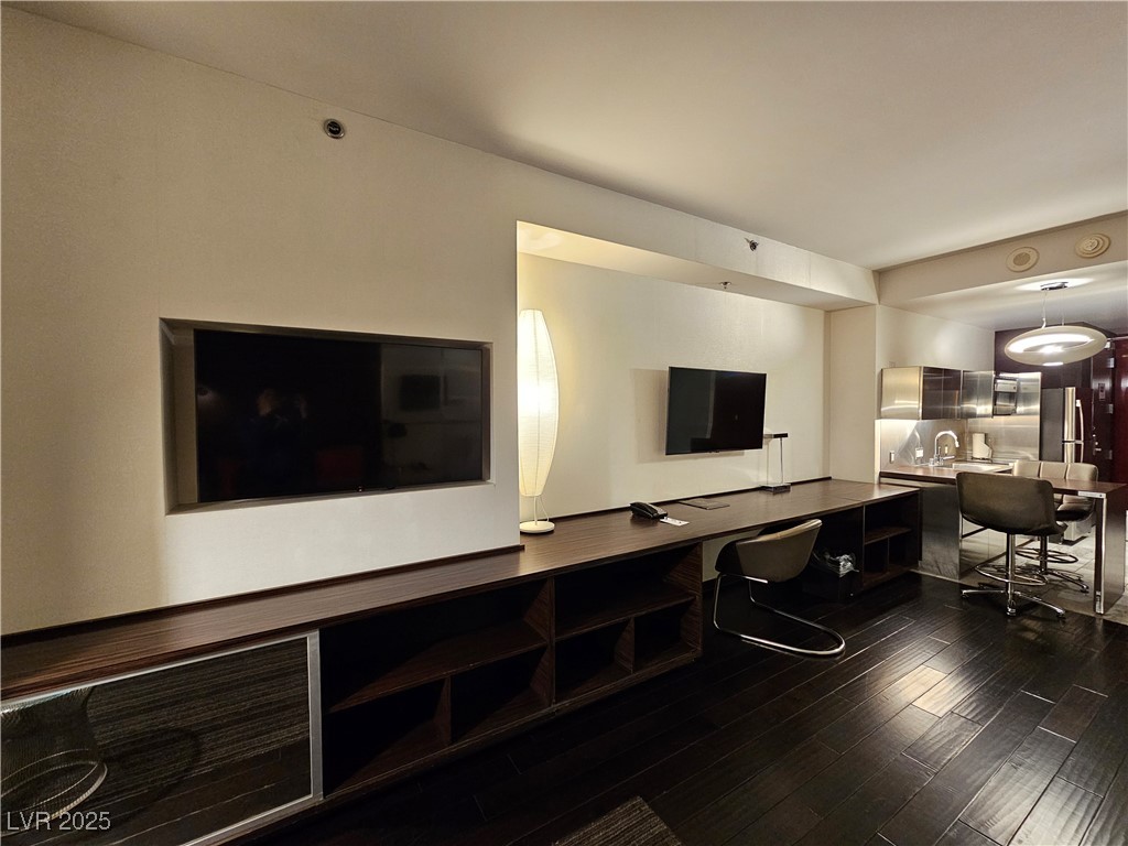 4381 West Flamingo Road, Unit 1806 Las Vegas, NV 89103 - Photo 7 of 12 Living area with dark wood-type flooring