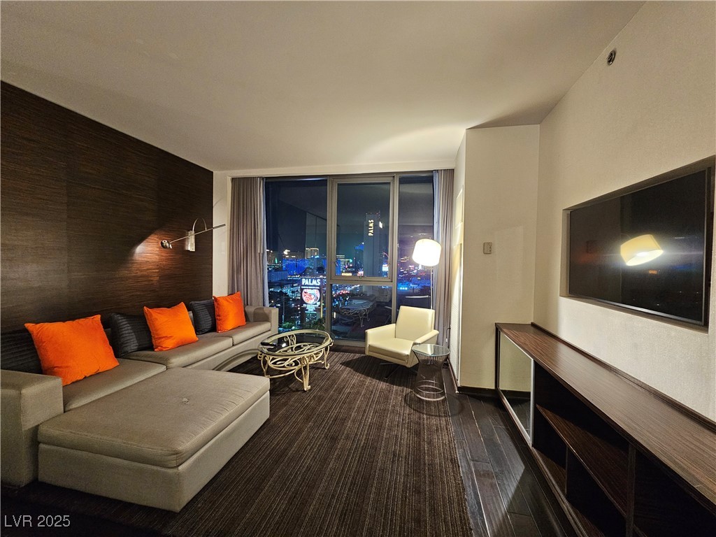 4381 West Flamingo Road, Unit 1806 Las Vegas, NV 89103 - Photo 8 of 12 Living area with a wall of windows and baseboards