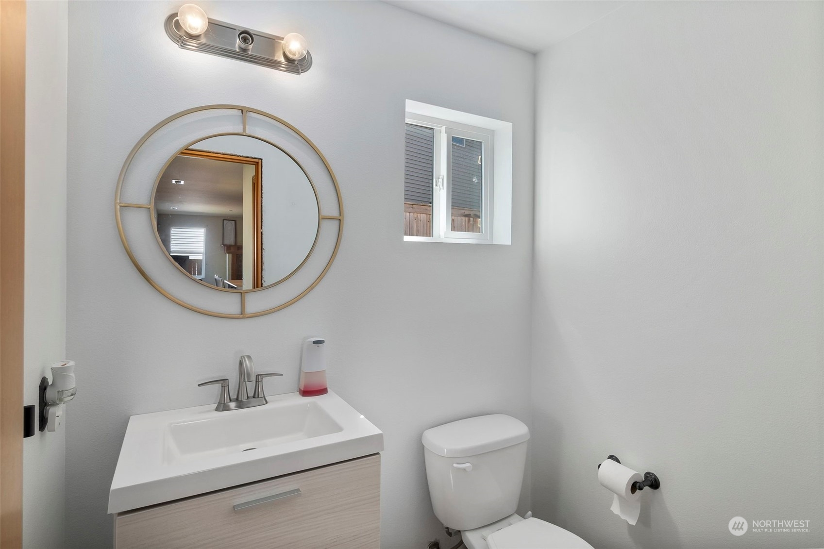 1332 Foreman Road DuPont, WA 98327 - Photo 14 of 32 a bathroom with a toilet a sink and a mirror