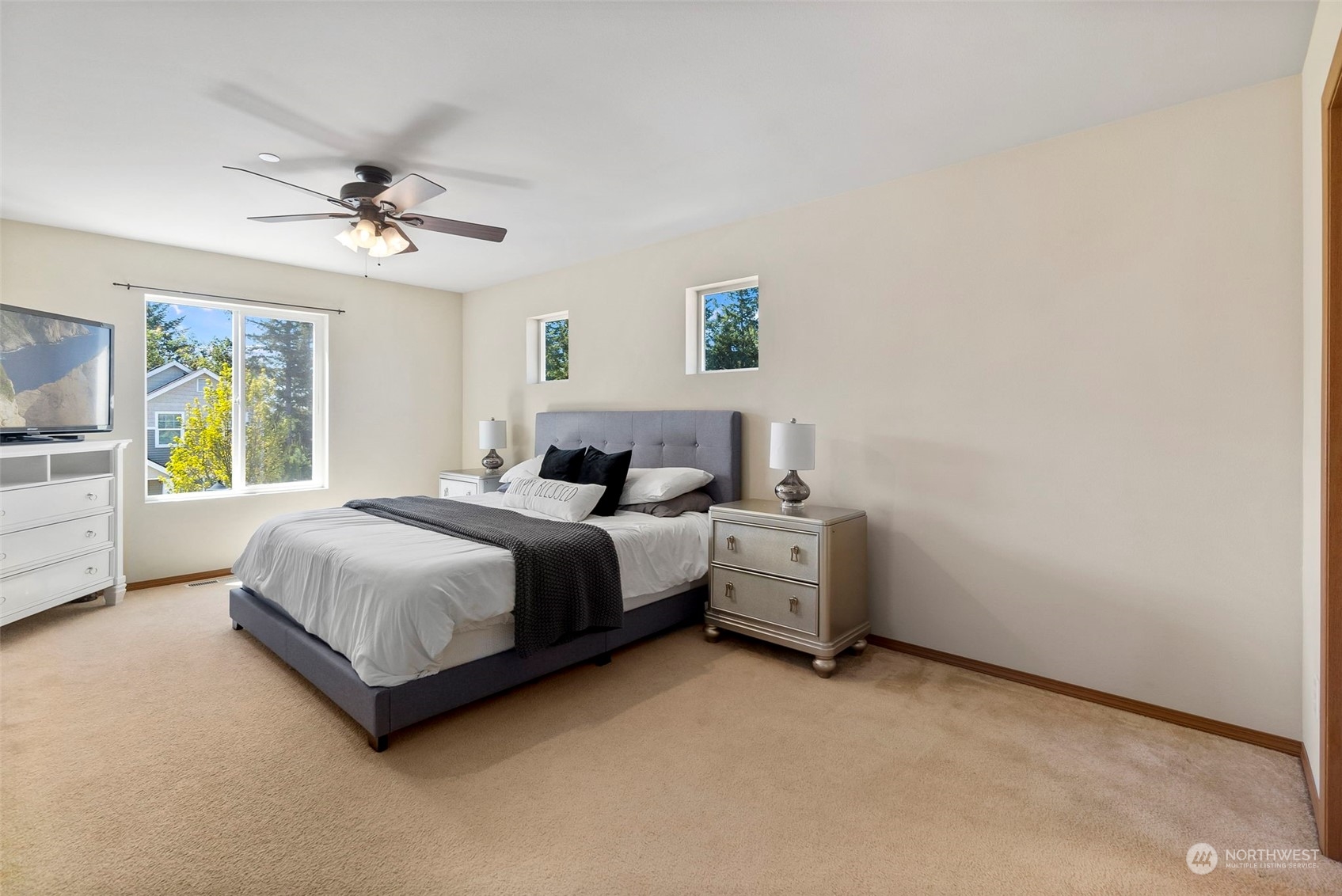 1332 Foreman Road DuPont, WA 98327 - Photo 23 of 32 a spacious bedroom with a bed and a chandelier
