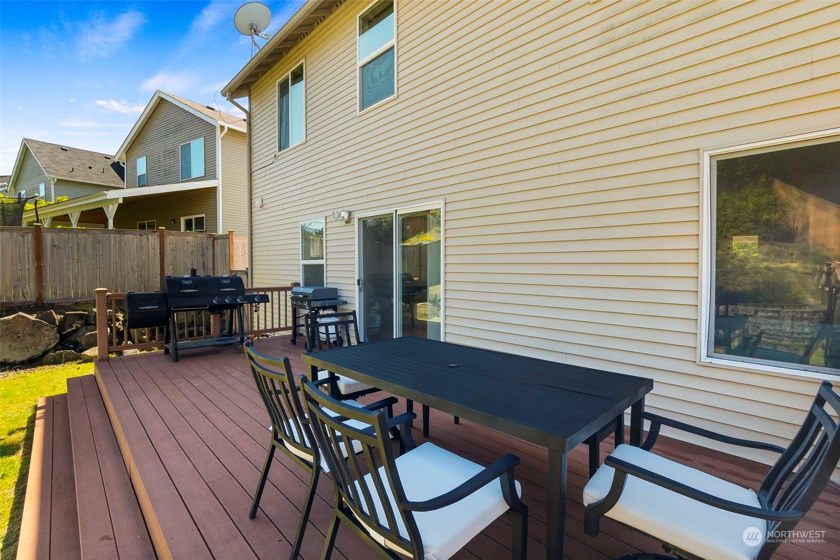1332 Foreman Road DuPont, WA 98327 - Photo 29 of 32 a view of a patio with table and chairs with wooden floor and fence
