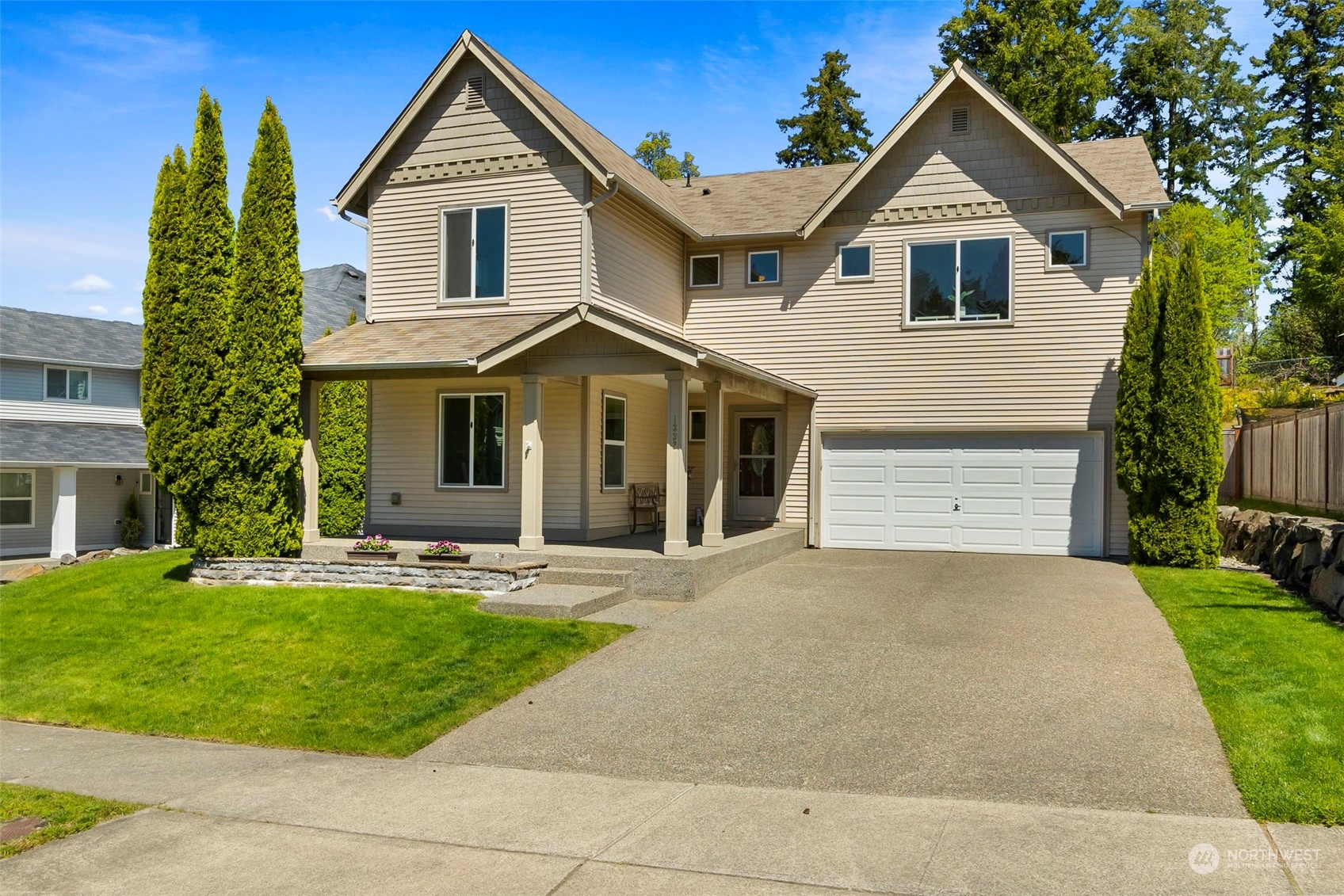 1332 Foreman Road DuPont, WA 98327 - Photo 4 of 32 a front view of a house with a yard and garage