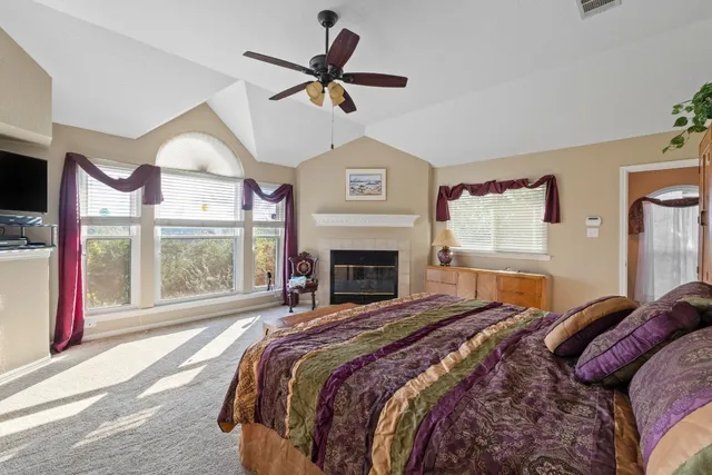 a bedroom with a large bed and a large window