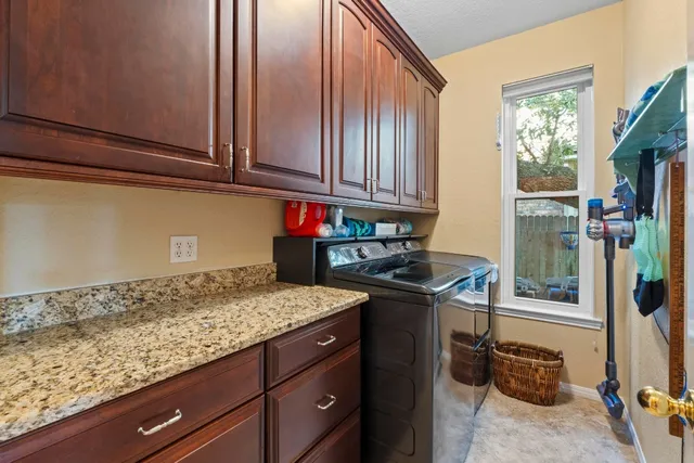 a kitchen with stainless steel appliances granite countertop a sink stove and cabinets