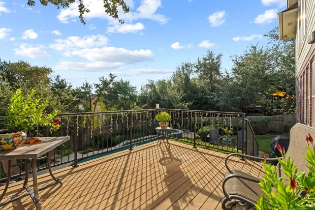 a view of a balcony with wooden floor and outdoor seating