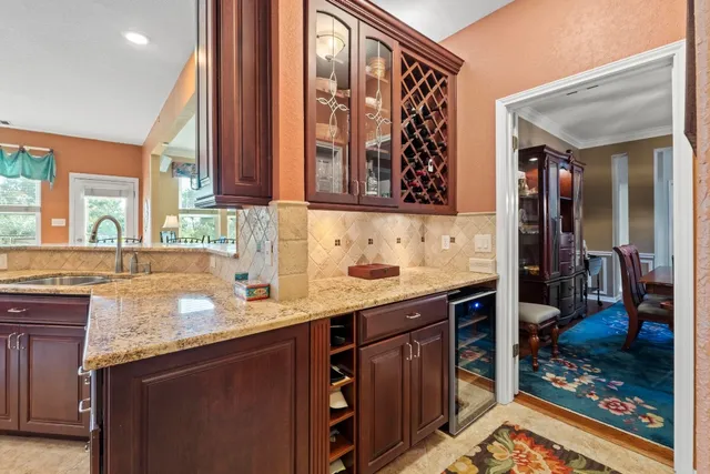 a kitchen with stainless steel appliances granite countertop a sink stove and cabinets