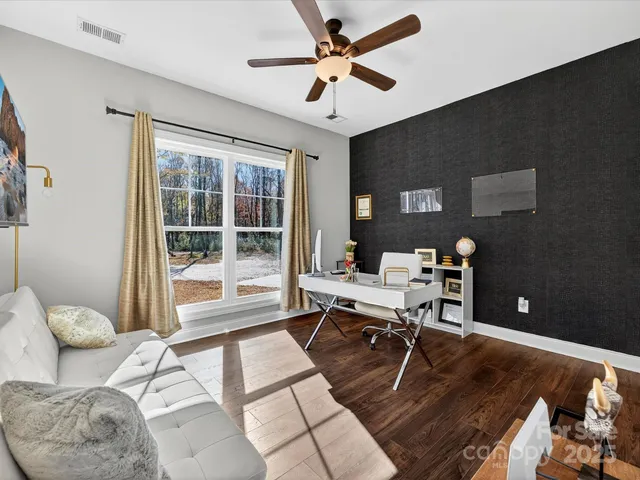 a workspace with furniture and a large window