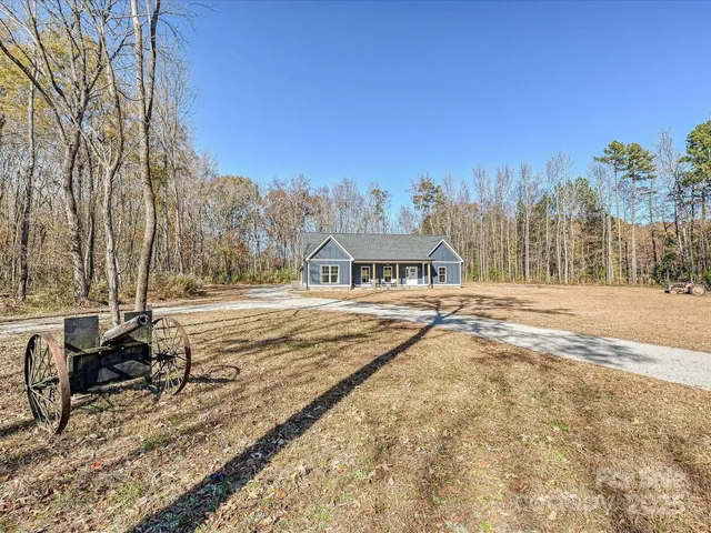 a view of residential houses with snow on the road