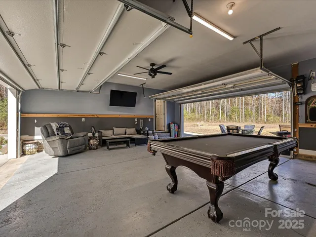 a room with furniture pool table and flat screen tv