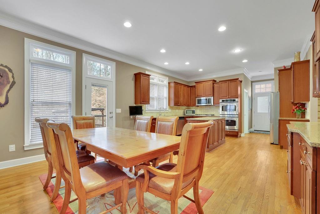 100 Trowbridge Road Atlanta, GA 30350 - Photo 16 of 49 a view of a dining room with furniture and a kitchen
