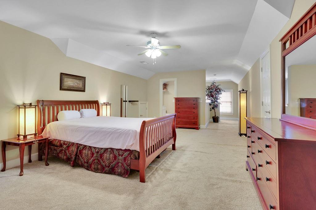 100 Trowbridge Road Atlanta, GA 30350 - Photo 23 of 42 a spacious bedroom with a bed and a chandelier