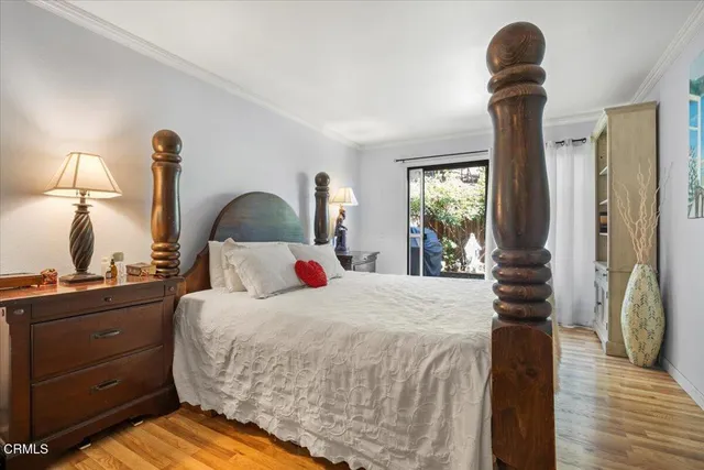 a bedroom with a bed and dresser with mirror