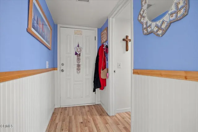 a dining room with furniture a chandelier and wooden floor