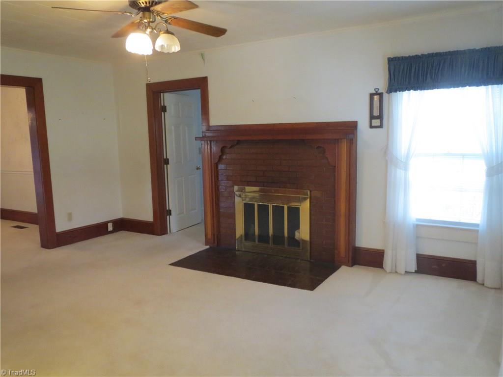 207 Ebenezer Church Road State Road, NC 28676 - Photo 8 of 30 Family room features fireplace and ceiling fan.