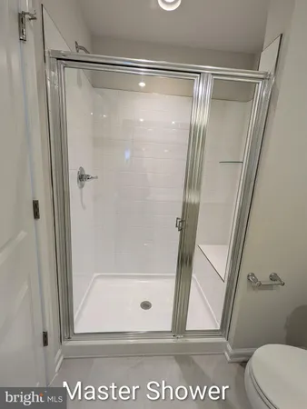 a bathroom with a glass shower door