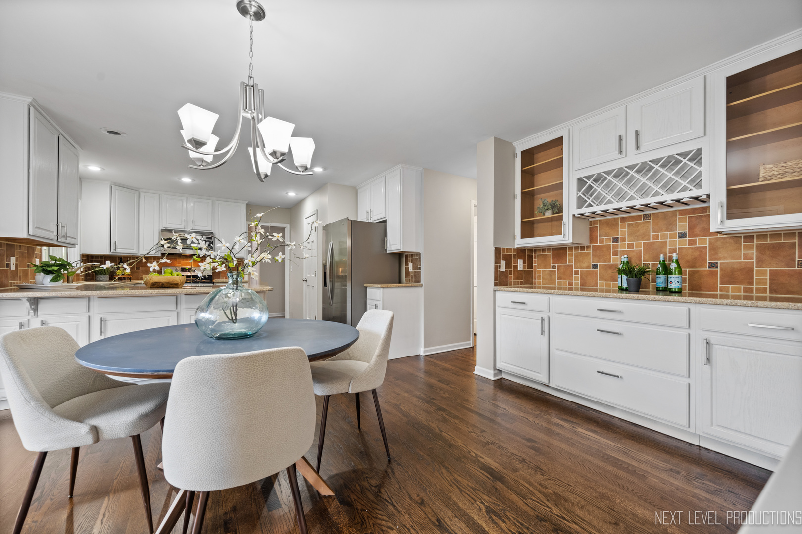 24 River Bend Road Montgomery, IL 60538 - Photo 13 of 36 a view of a dining room with furniture a chandelier and wooden floor