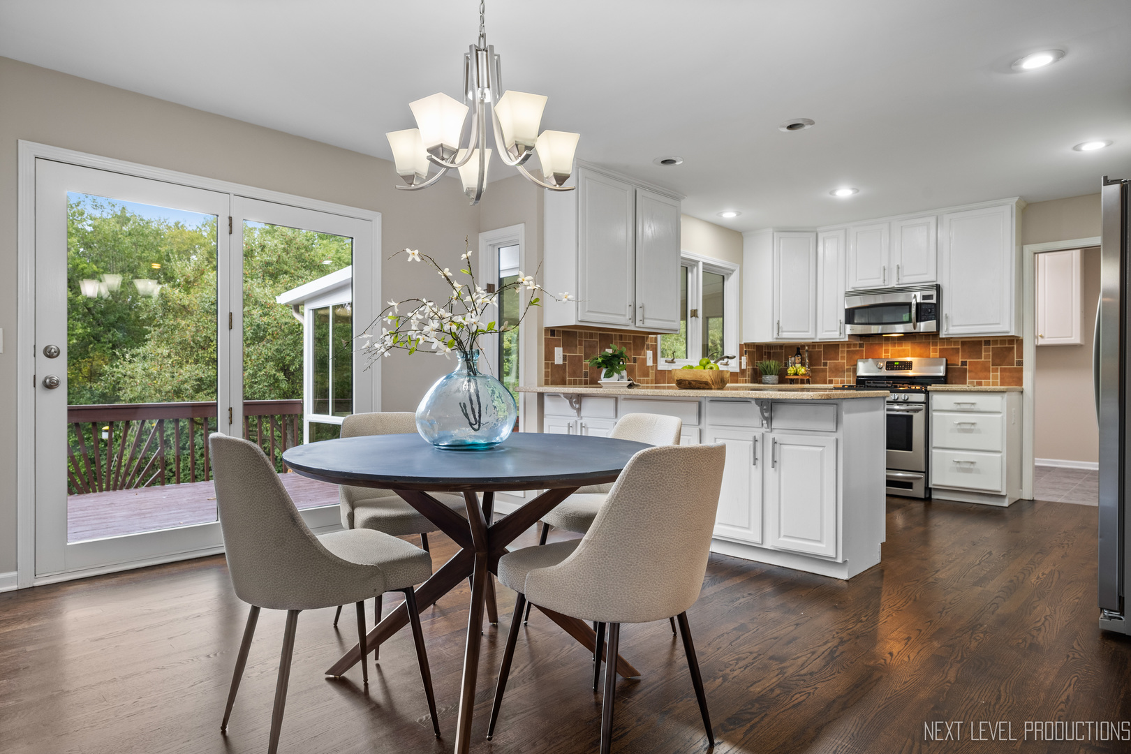 24 River Bend Road Montgomery, IL 60538 - Photo 14 of 36 a dining room filled chandelier and wooden floor