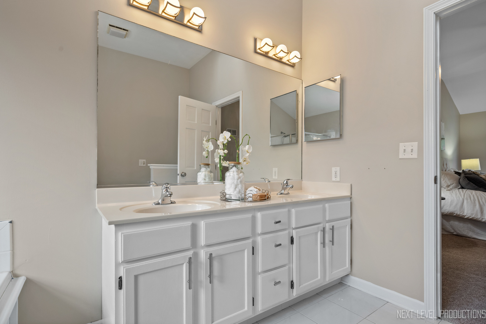 24 River Bend Road Montgomery, IL 60538 - Photo 25 of 36 a en suite bathroom with a double vanity sink and a mirror