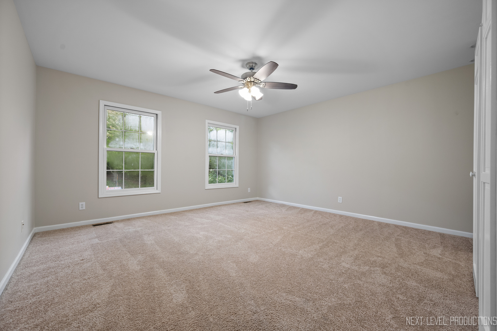 24 River Bend Road Montgomery, IL 60538 - Photo 26 of 36 an empty room with windows and fan