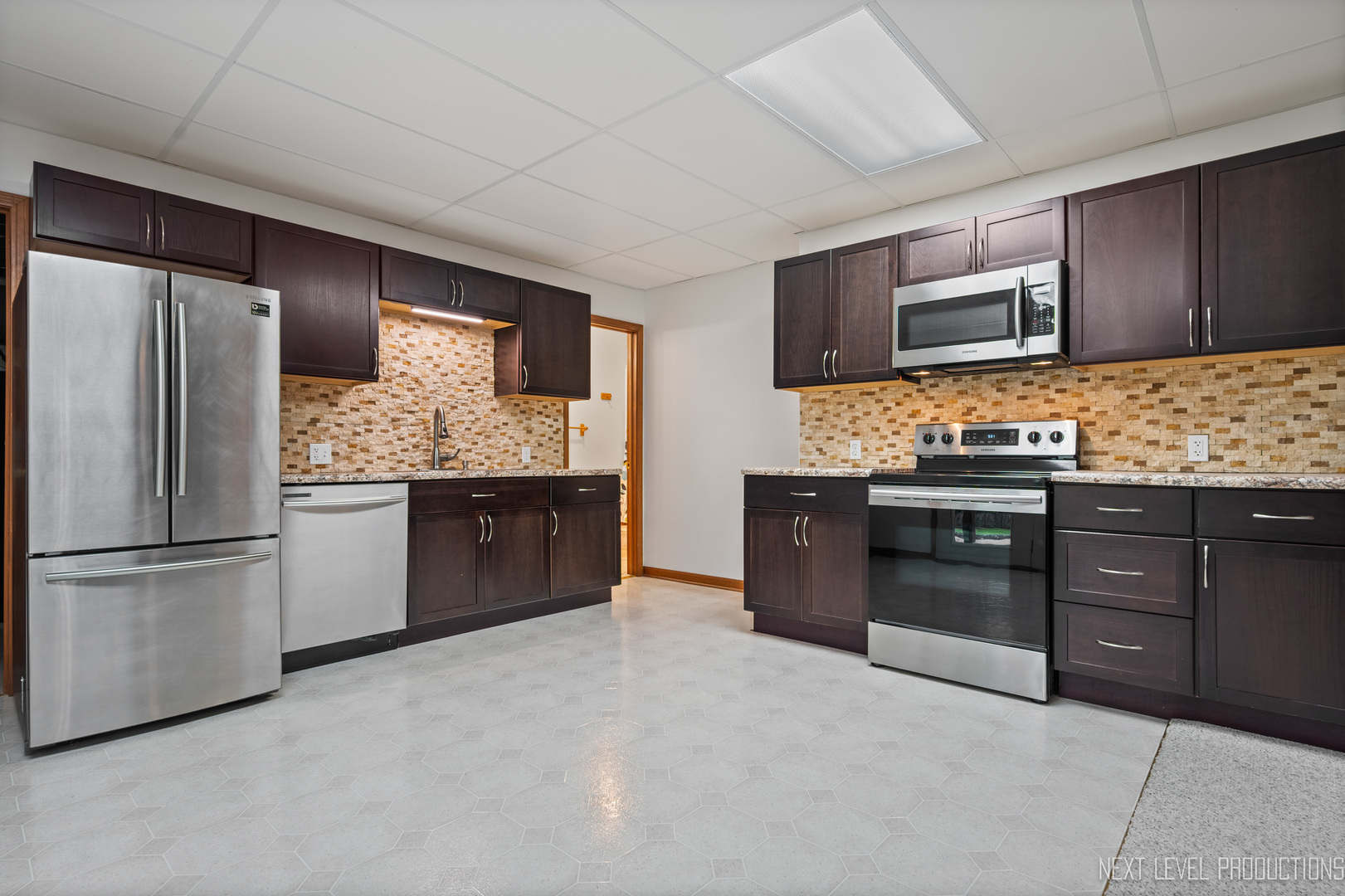 24 River Bend Road Montgomery, IL 60538 - Photo 32 of 36 a kitchen with stainless steel appliances granite countertop a refrigerator and a stove top oven