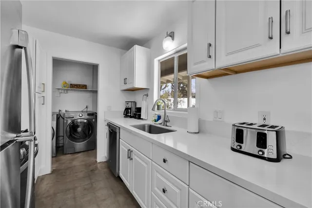 a kitchen with stainless steel appliances granite countertop a sink and cabinets