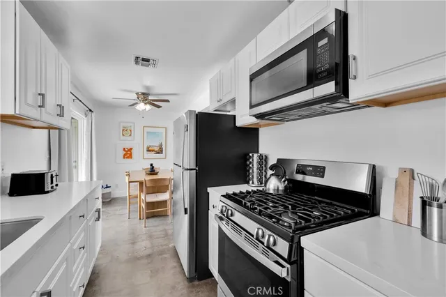 a kitchen with stainless steel appliances granite countertop a stove and a refrigerator